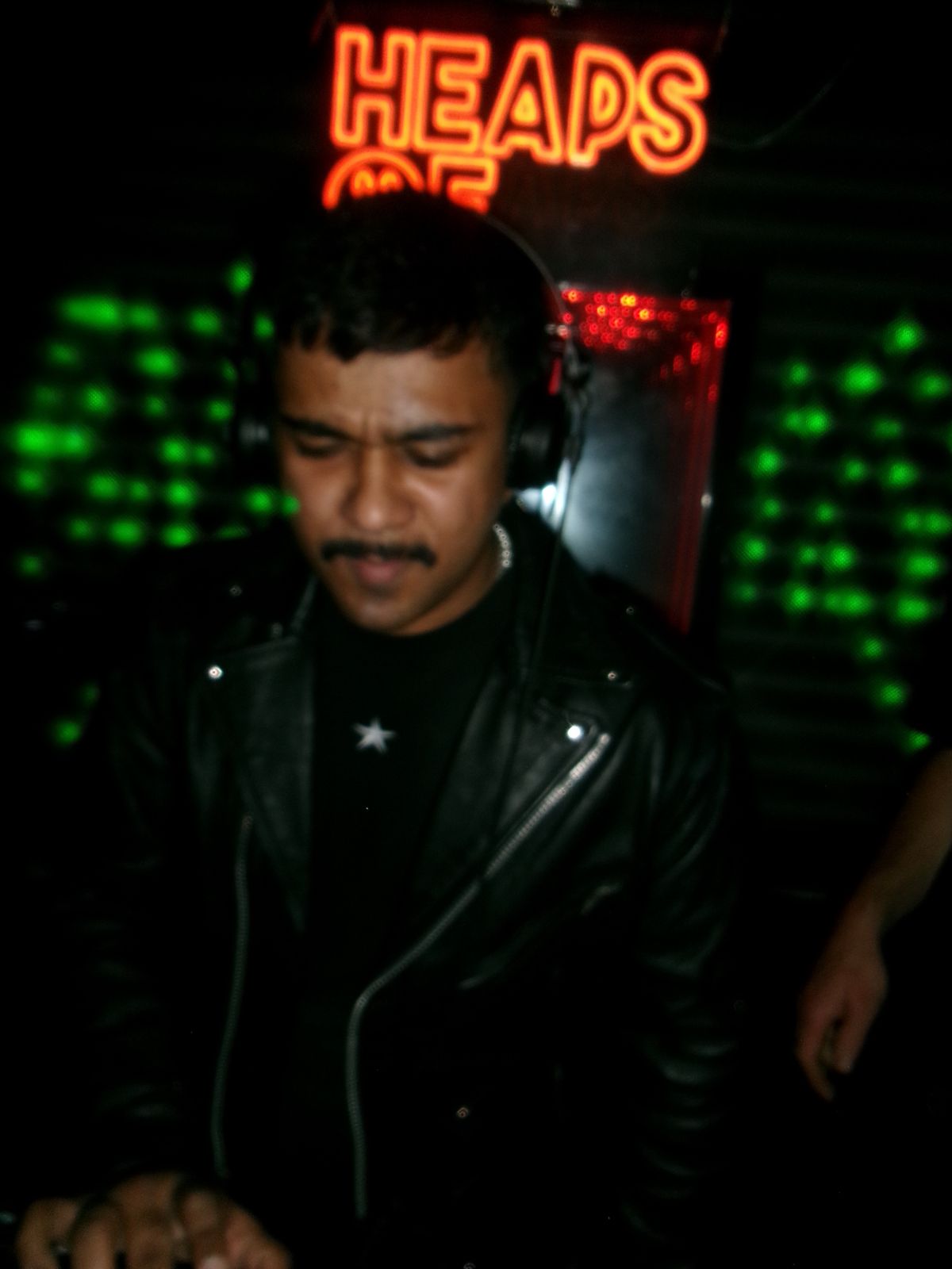 Rummie on the decks in headphones at Heaps Of.