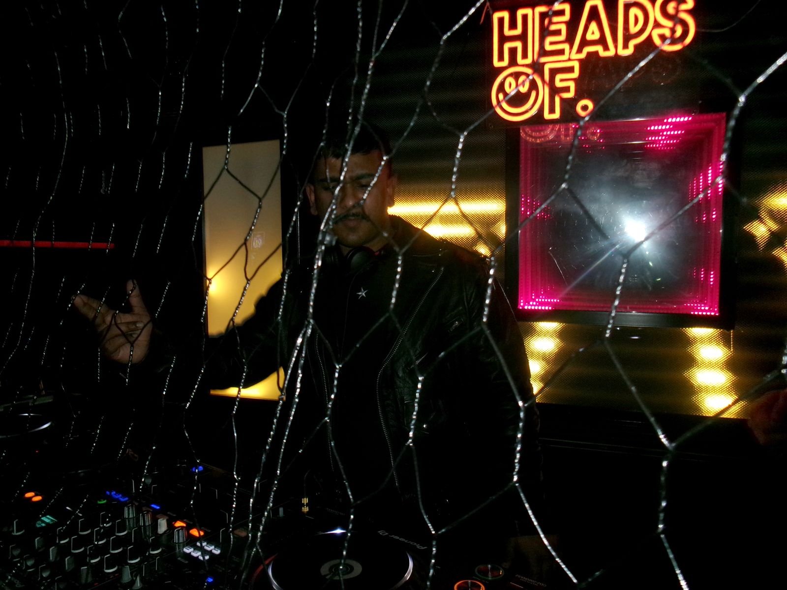 Rummie in the booth under the Heaps Of. neon sign